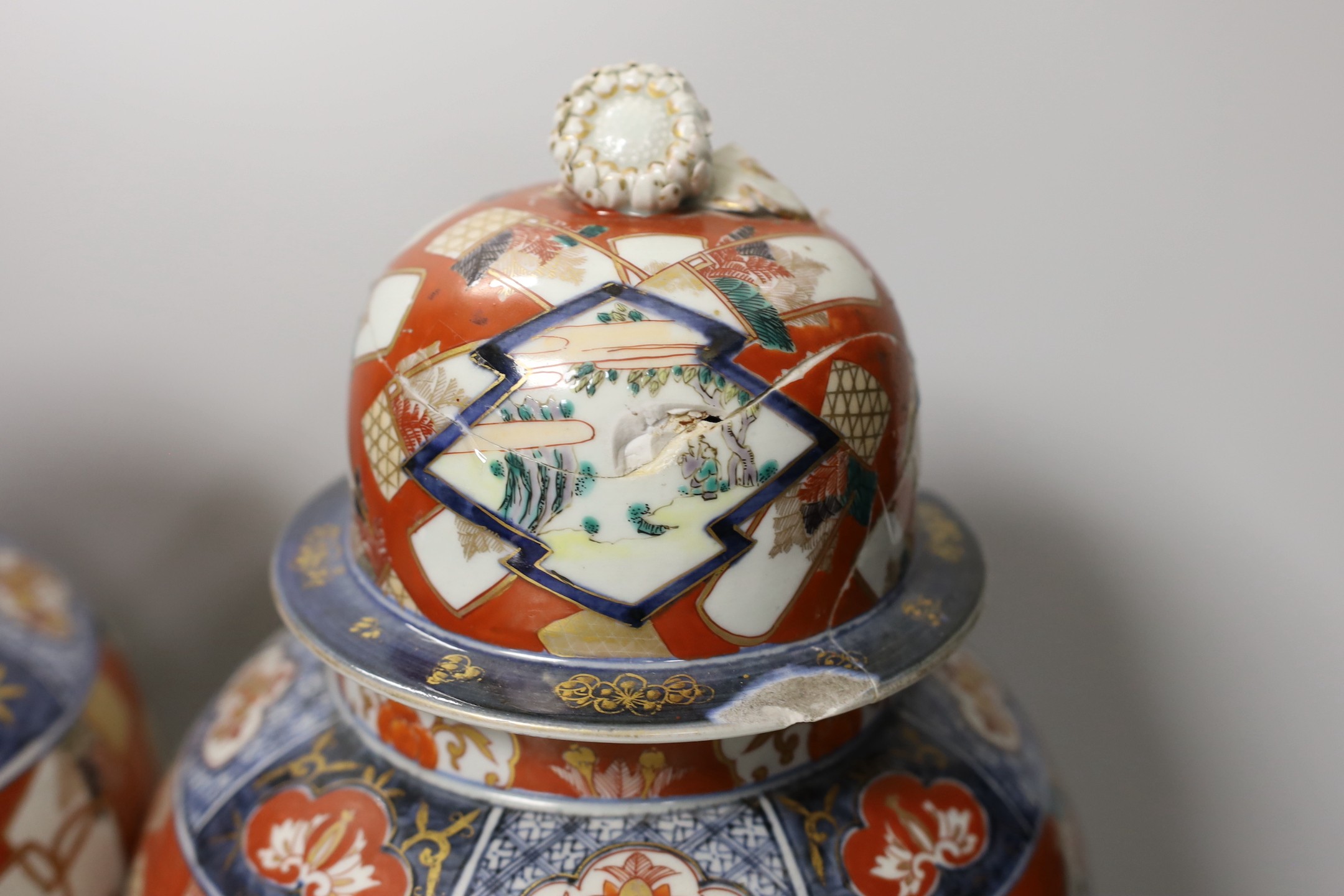 A pair of Imari vases and covers. 39cm high